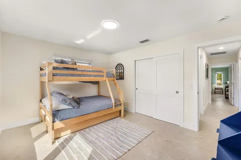 a bedroom with furniture and a wooden floor