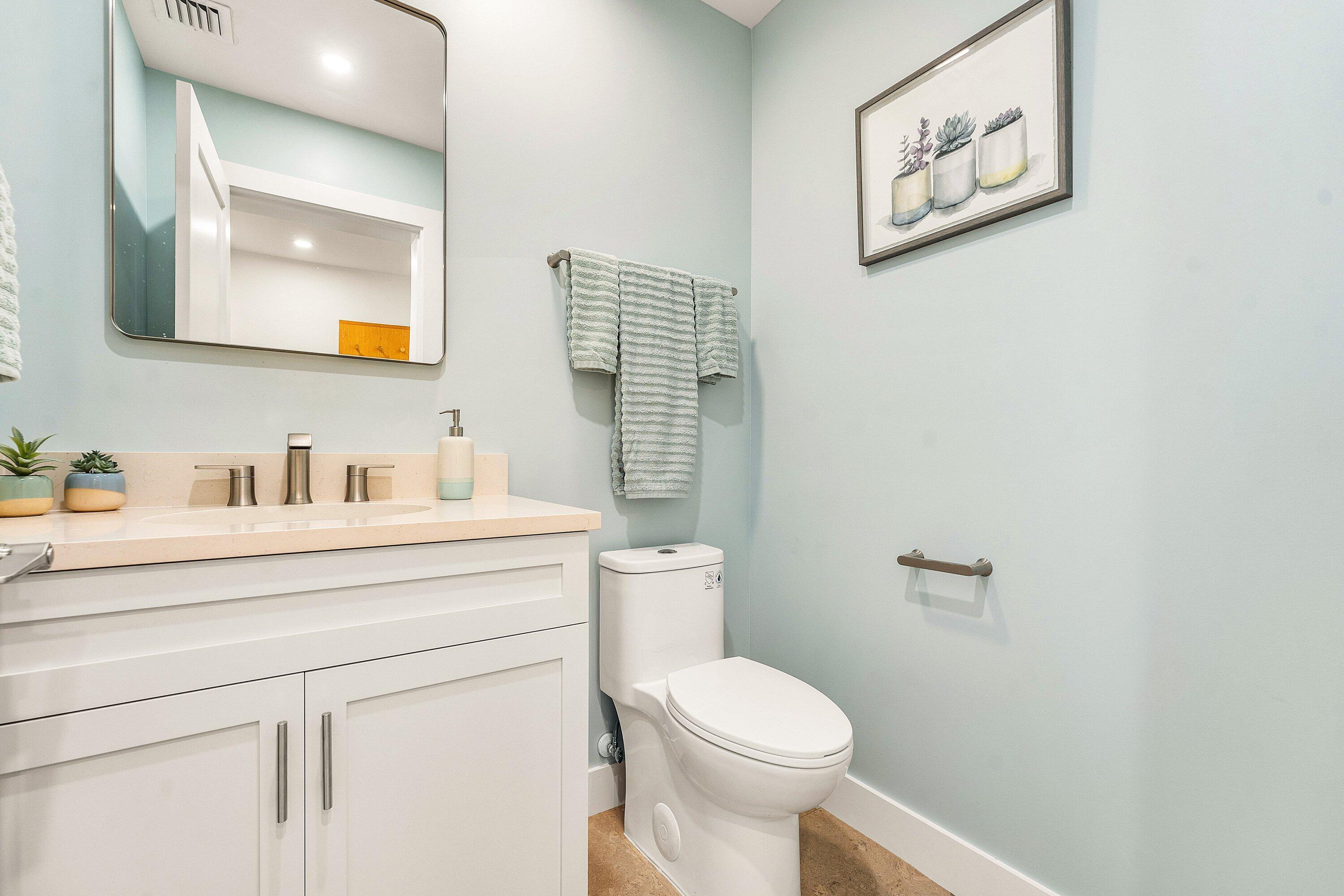 1070 Marble Way Boca Raton, FL 33432 - Photo 26 of 39 a bathroom with a toilet sink vanity and mirror