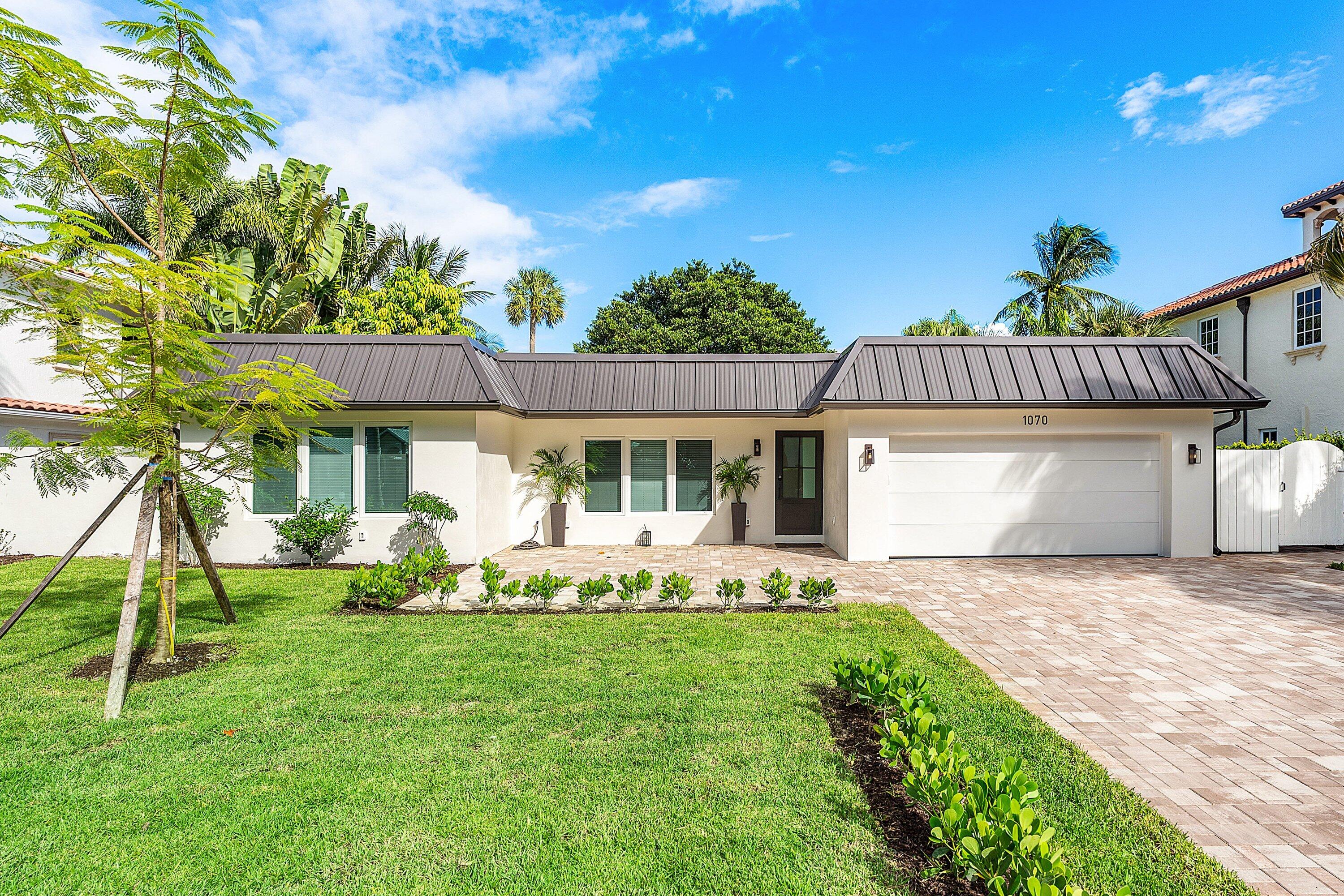 1070 Marble Way Boca Raton, FL 33432 - Photo 3 of 39 a front view of a house with garden