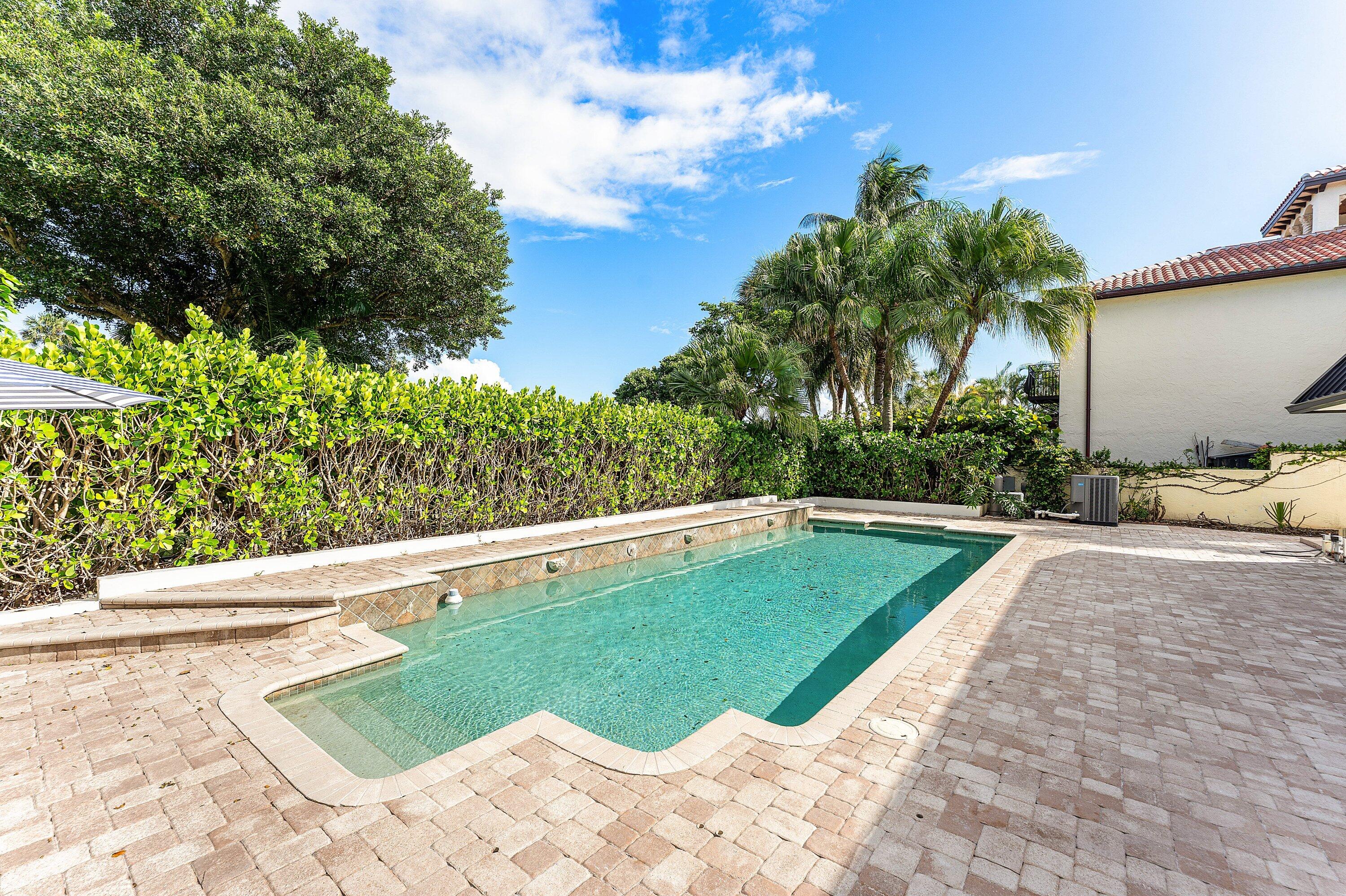 1070 Marble Way Boca Raton, FL 33432 - Photo 31 of 39 a view of a swimming pool with a garden