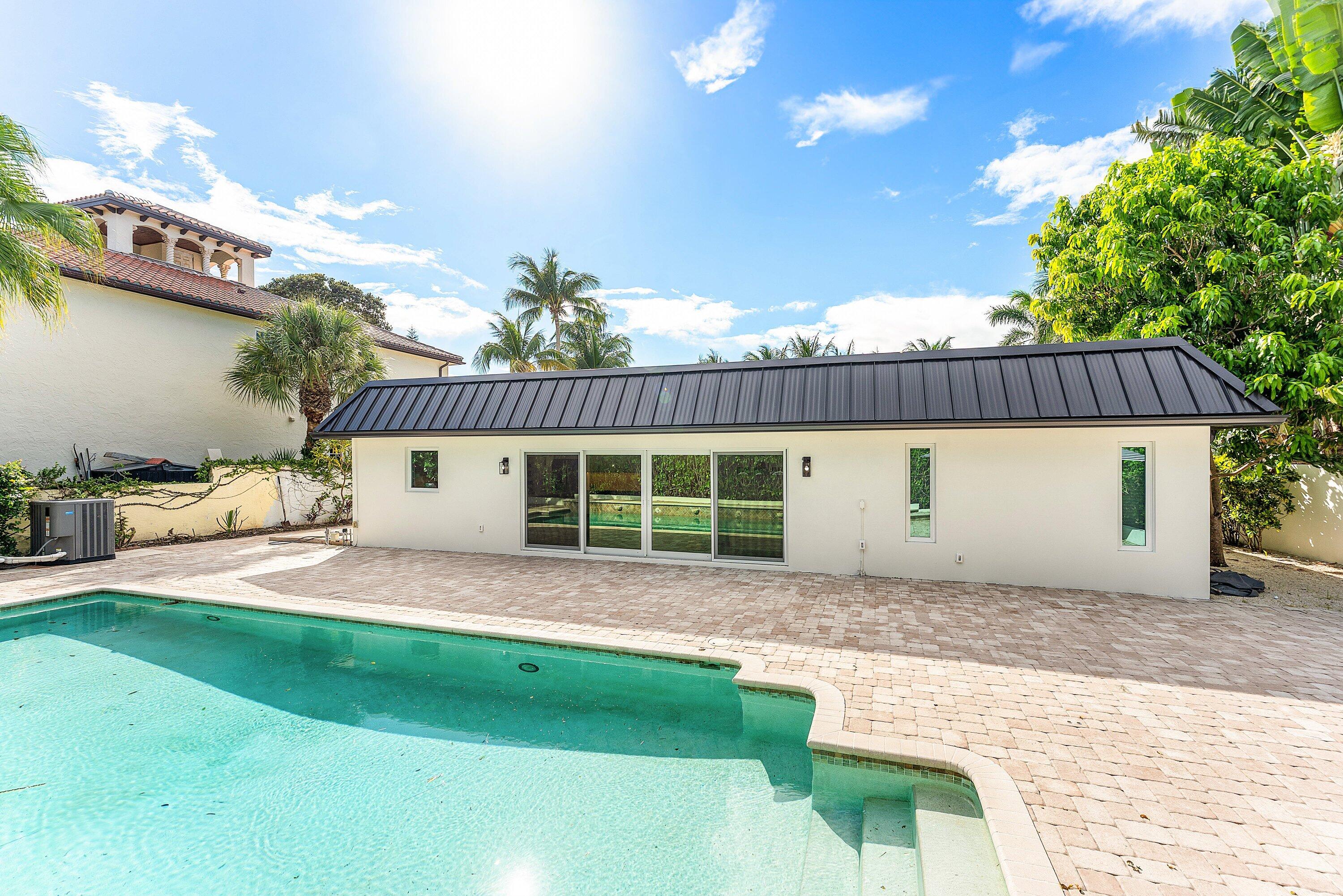 1070 Marble Way Boca Raton, FL 33432 - Photo 34 of 39 a front view of a house with a garden and yard