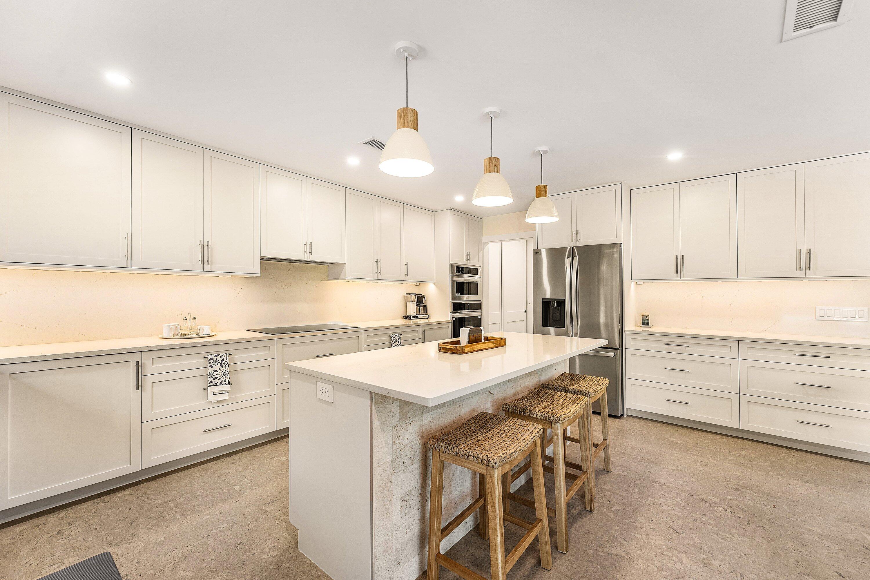 1070 Marble Way Boca Raton, FL 33432 - Photo 8 of 39 a kitchen with white cabinets and white appliances