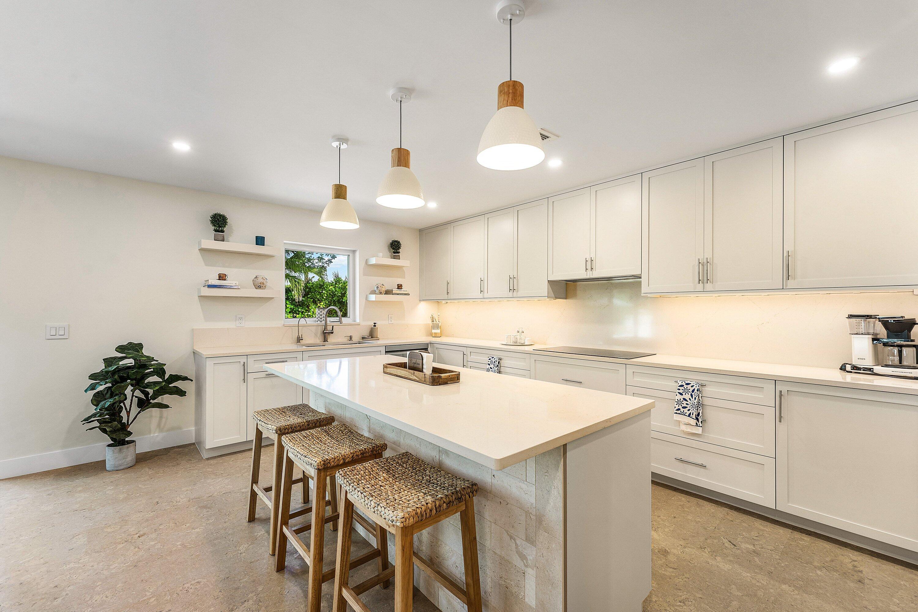 1070 Marble Way Boca Raton, FL 33432 - Photo 9 of 39 a kitchen with a sink a center island and cabinets