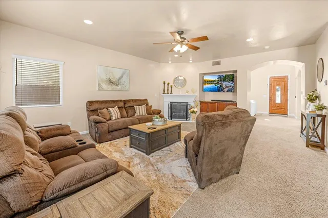 a living room with furniture and a chandelier
