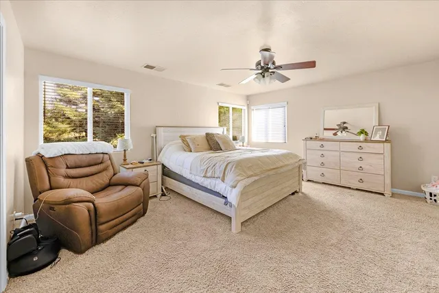 a spacious bedroom with a bed and a couch