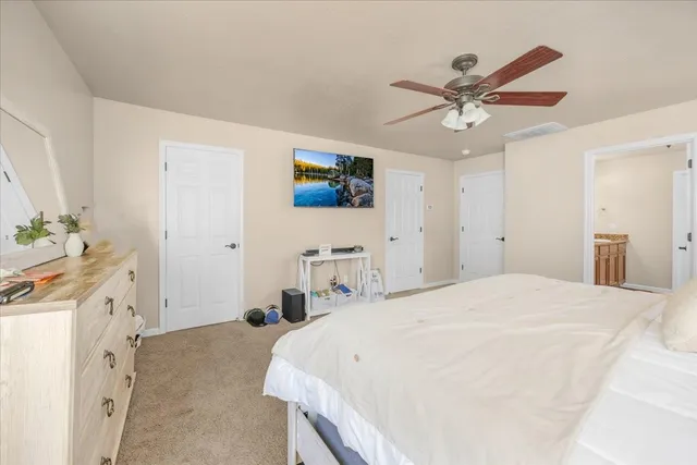a bedroom with a bed dresser and a window