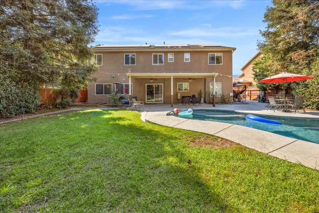a front view of house with yard and outdoor seating