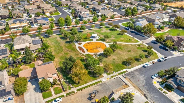 an aerial view of a residential houses with outdoor space
