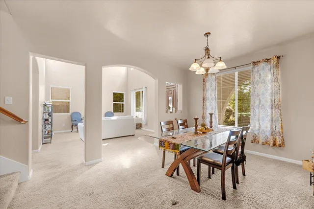 a view of a dining room with furniture and window