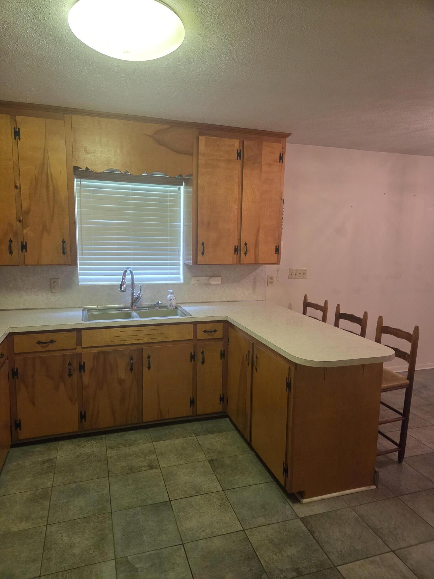 814 Maple Street Chipley, FL 32428 - Photo 9 of 15 a kitchen with a sink a stove and cabinets