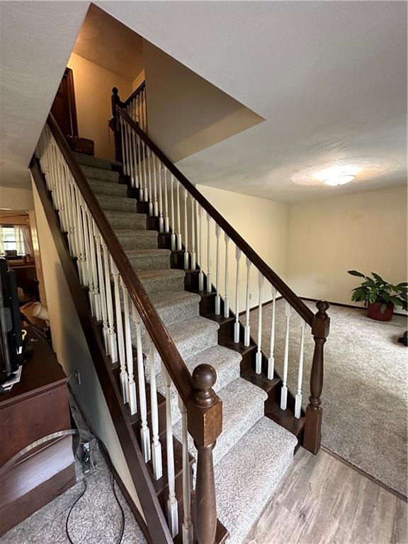 2646 Hood School Road Indiana, PA 15701 - Photo 6 of 21 a view of staircase with lots of frames on wall and wooden floor