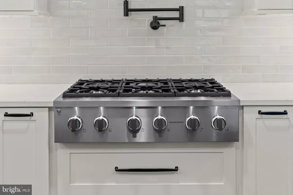 a close view of stove top oven with granite countertops