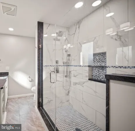 a bathroom with a shower and a sink
