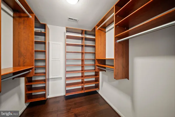 a view of walk in closet with empty racks