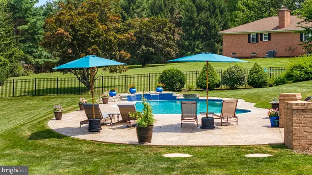a view of a house with backyard sitting area and garden