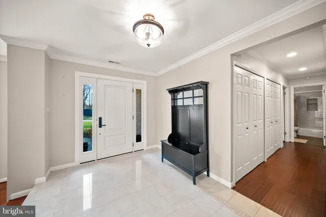 a view of a livingroom with wooden floor and bathroom
