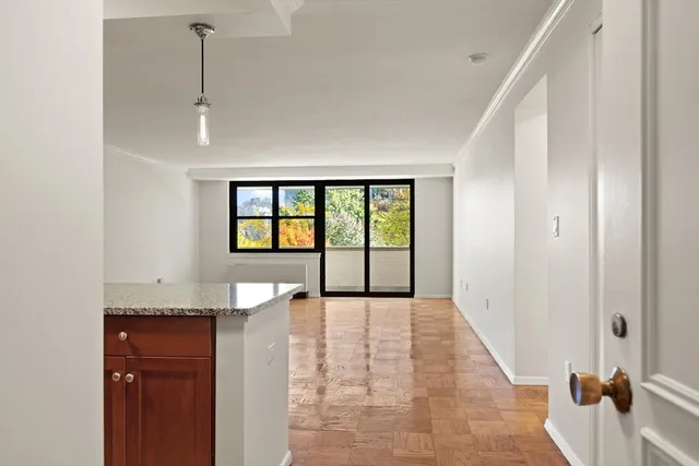 a view of a kitchen with a sink and a large window