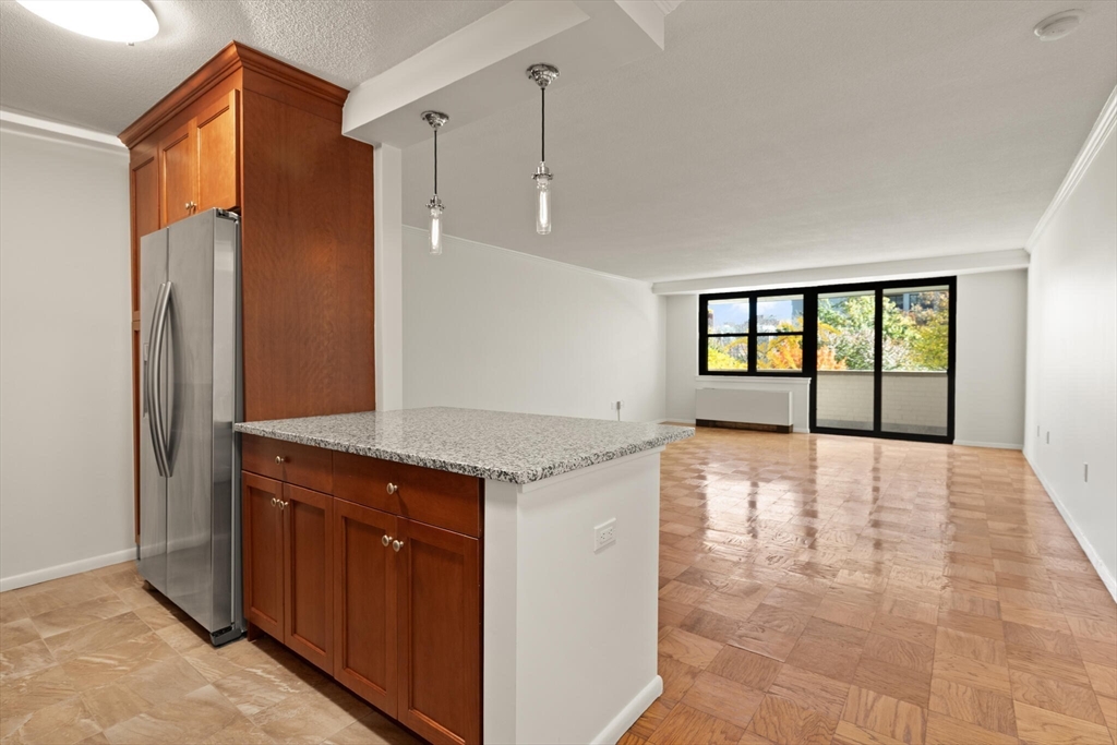 2 Hawthorne Place, Unit 5H Boston, MA 02114 - Photo 4 of 21 a view of a kitchen with a sink and a large window