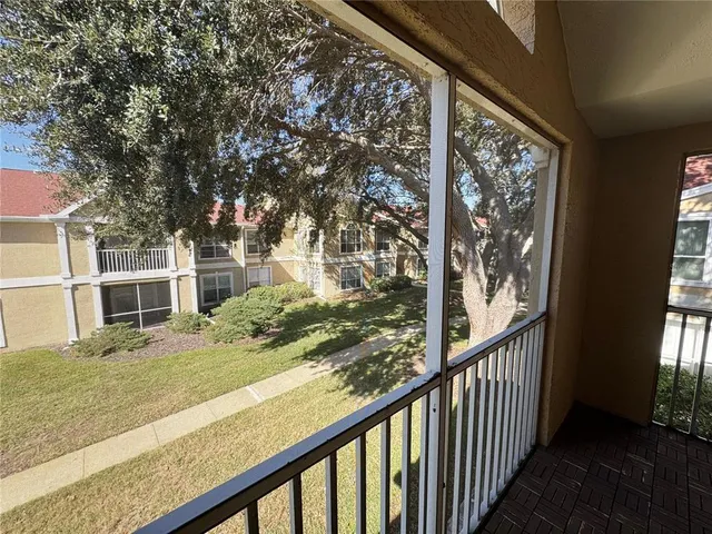 a view of a balcony with wooden floor