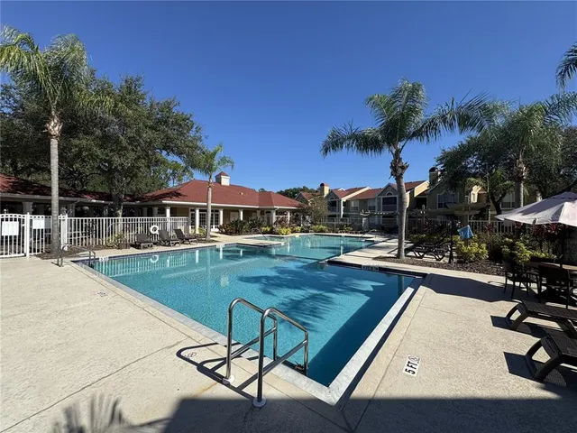 a view of a swimming pool with lounge chairs
