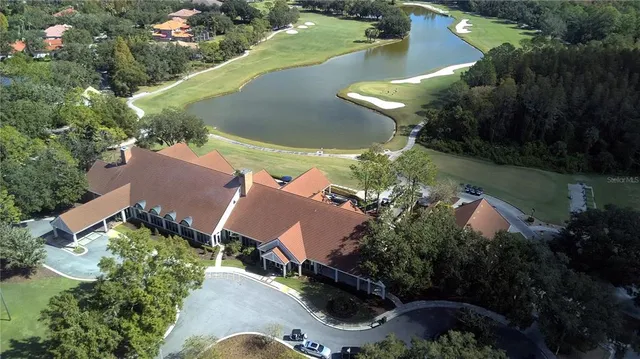 an aerial view of a house with a yard and lake view