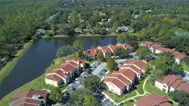an aerial view of residential house with outdoor space and lake view