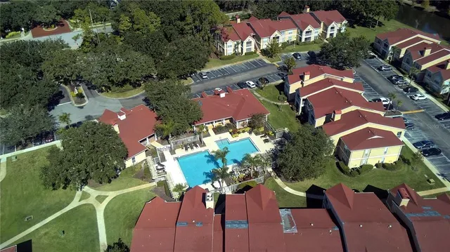 an aerial view of a house with yard swimming pool and outdoor seating