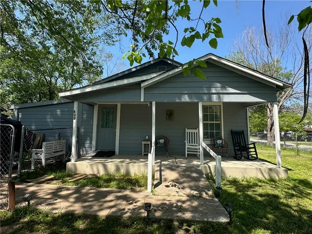 a backyard of a house with yard and outdoor seating