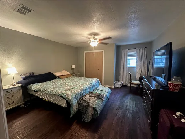 a living room with furniture and a gym machine