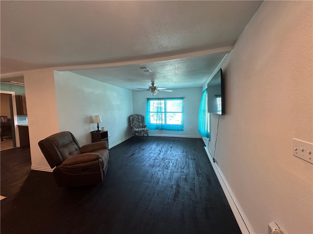 409 Houston Street Mexia, TX 76667 - Photo 2 of 33 a living room with furniture and a wooden floor