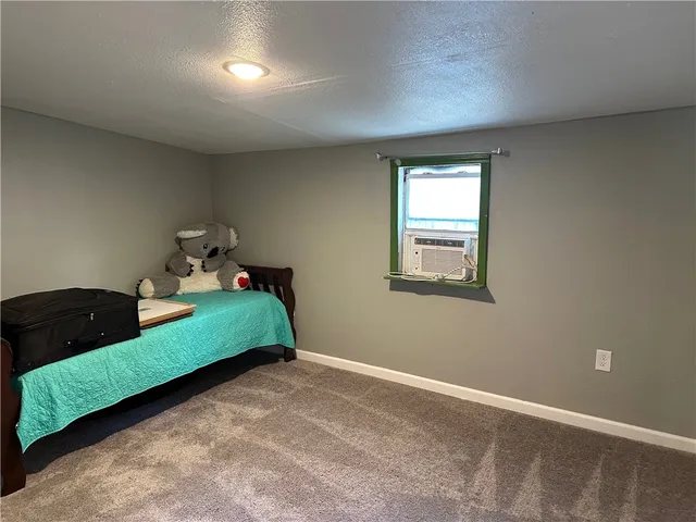 a room with a bed and window