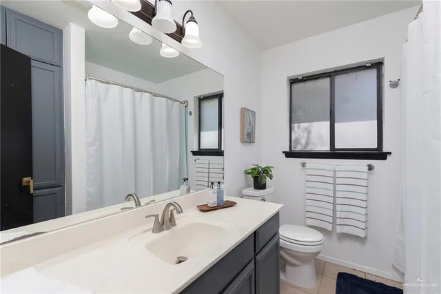 a bathroom with a sink a mirror and a window