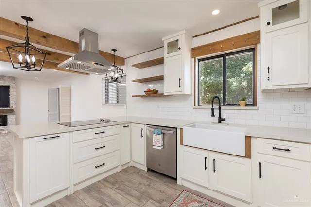 a kitchen with white cabinets and window