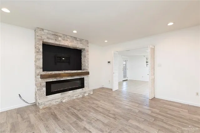 a room with wooden floor and ceiling fan