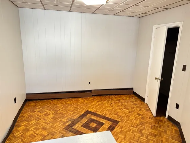 a view of a room with wooden floor and bench