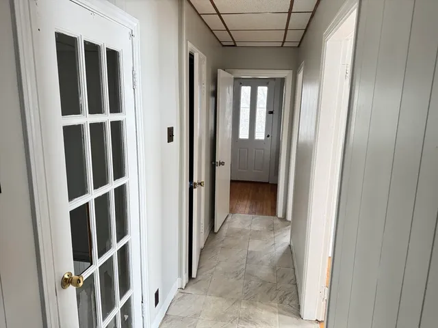 a view of a hallway with wooden floor and entryway