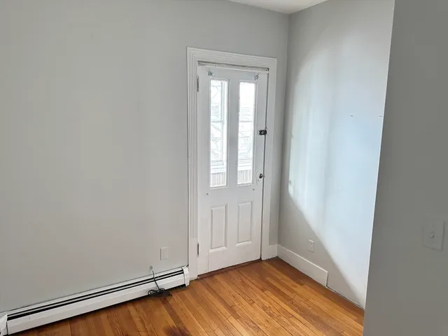 an empty room with wooden floor and closet