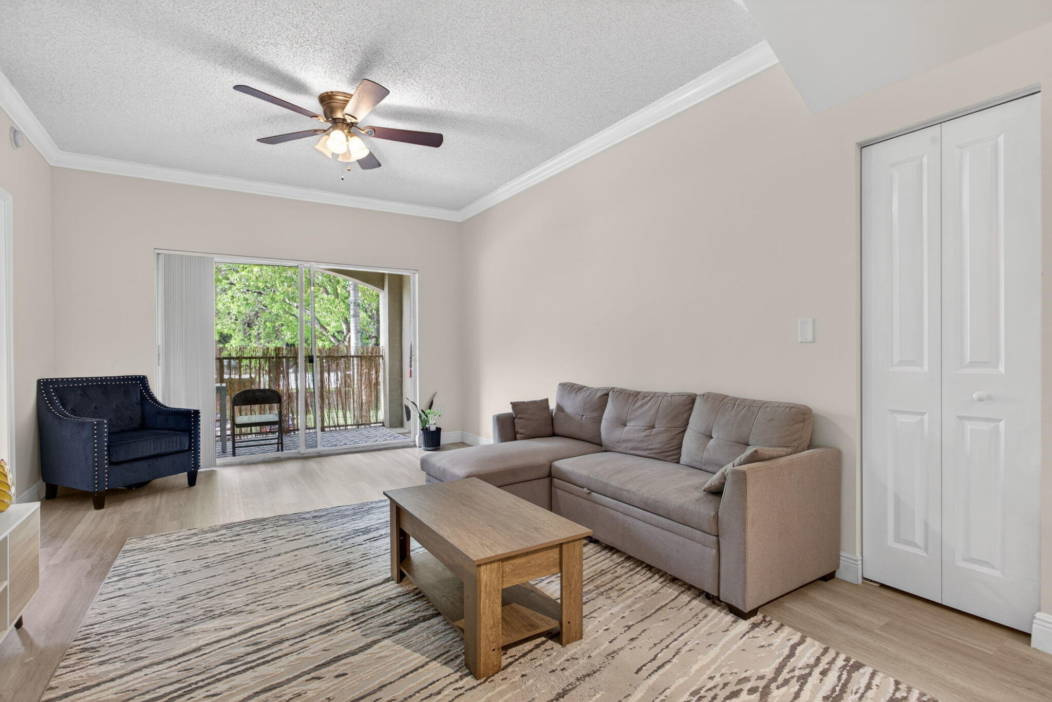 5880 West Sample Road, Unit 206 Coral Springs, FL 33067 - Photo 11 of 37 a living room with furniture and a window