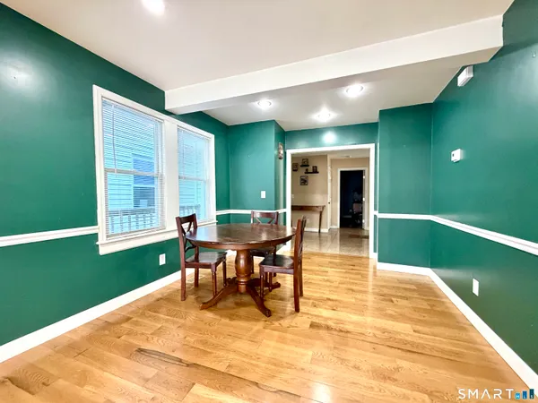 a view of a livingroom with furniture window and wooden floor