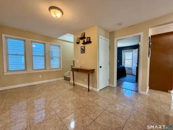 a kitchen with stainless steel appliances granite countertop a refrigerator a stove and a wooden floors