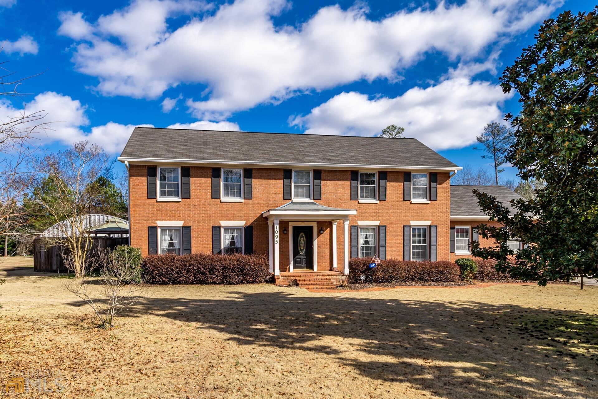 1095 Crawford Street Madison, GA 30650 - Photo 1 of 1 a front view of a house with a yard