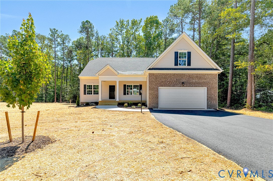 8355 Patrick Henry Boulevard Mechanicsville, VA 23116 - Photo 1 of 48 a front view of a house with a yard and garage
