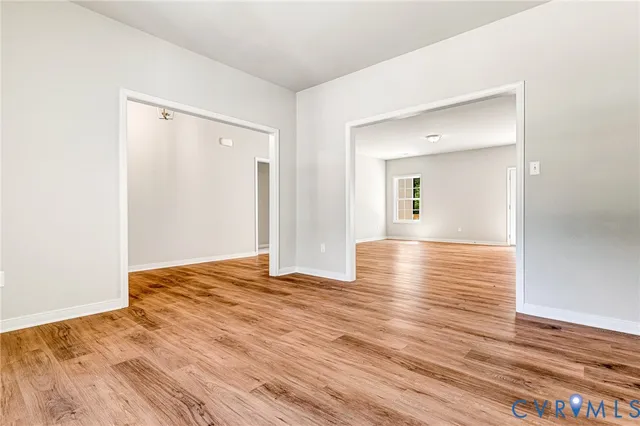 a kitchen with granite countertop a sink a stove and a wooden floors