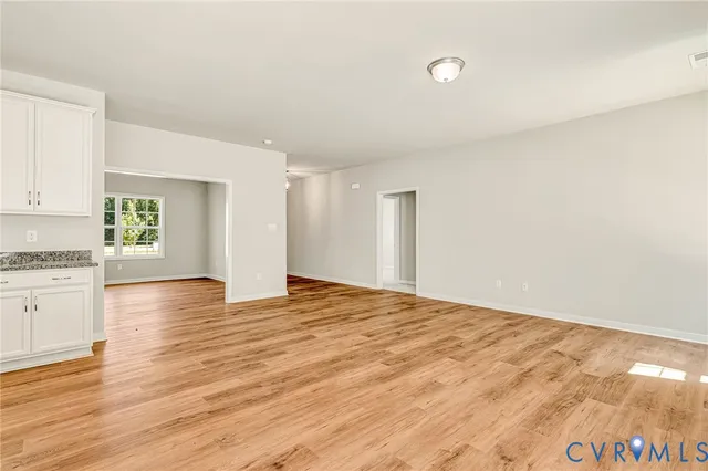 a kitchen with granite countertop sink stove and cabinets