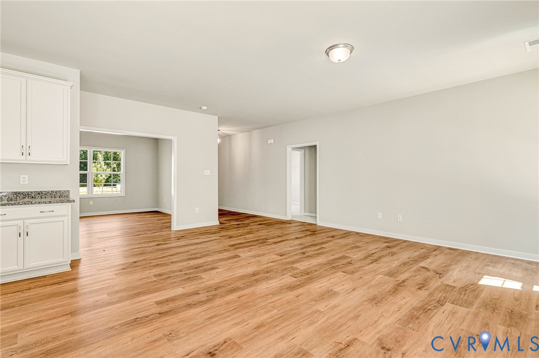 8355 Patrick Henry Boulevard Mechanicsville, VA 23116 - Photo 13 of 48 a view of empty room with wooden floor and window
