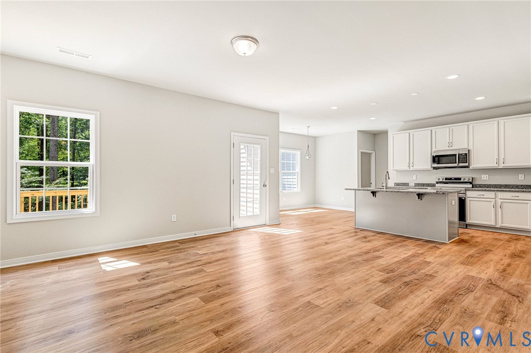 8355 Patrick Henry Boulevard Mechanicsville, VA 23116 - Photo 15 of 48 a view of an empty room with wooden floor and a window