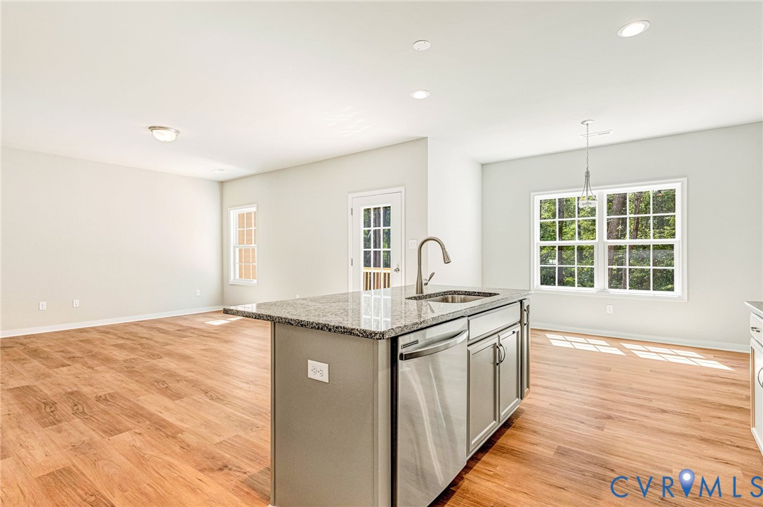 8355 Patrick Henry Boulevard Mechanicsville, VA 23116 - Photo 20 of 48 a kitchen with granite countertop sink stove and cabinets