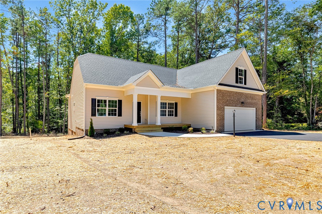 8355 Patrick Henry Boulevard Mechanicsville, VA 23116 - Photo 2 of 48 a front view of a house with a yard and garage