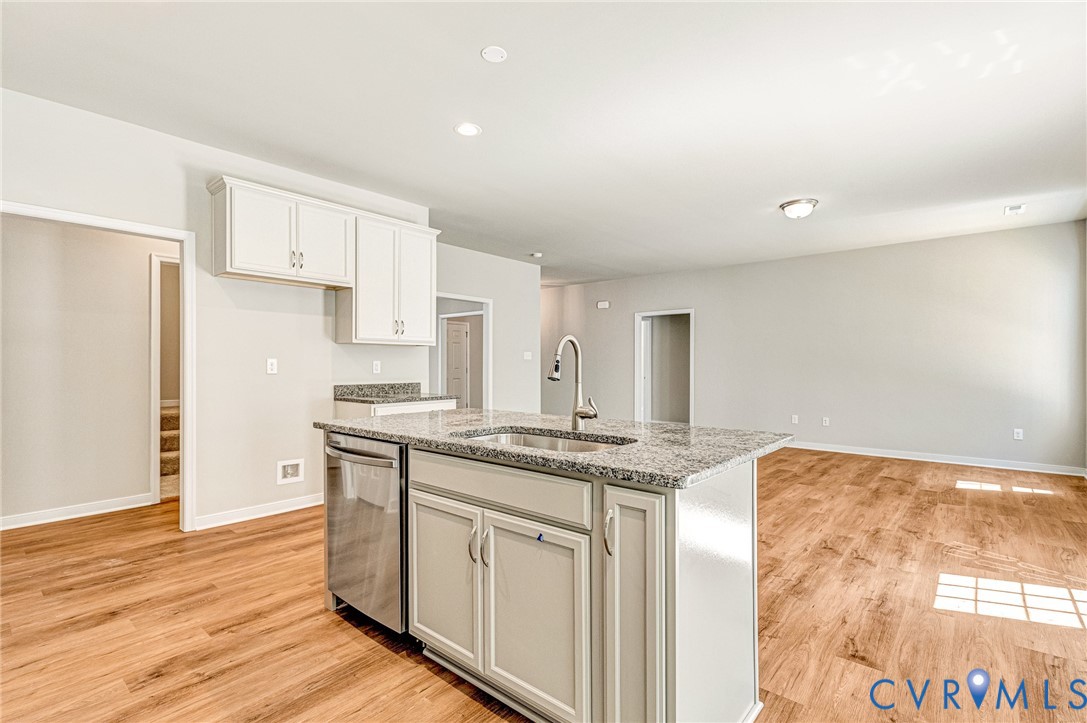 8355 Patrick Henry Boulevard Mechanicsville, VA 23116 - Photo 21 of 48 a kitchen with stainless steel appliances granite countertop a sink and cabinets with wooden floor