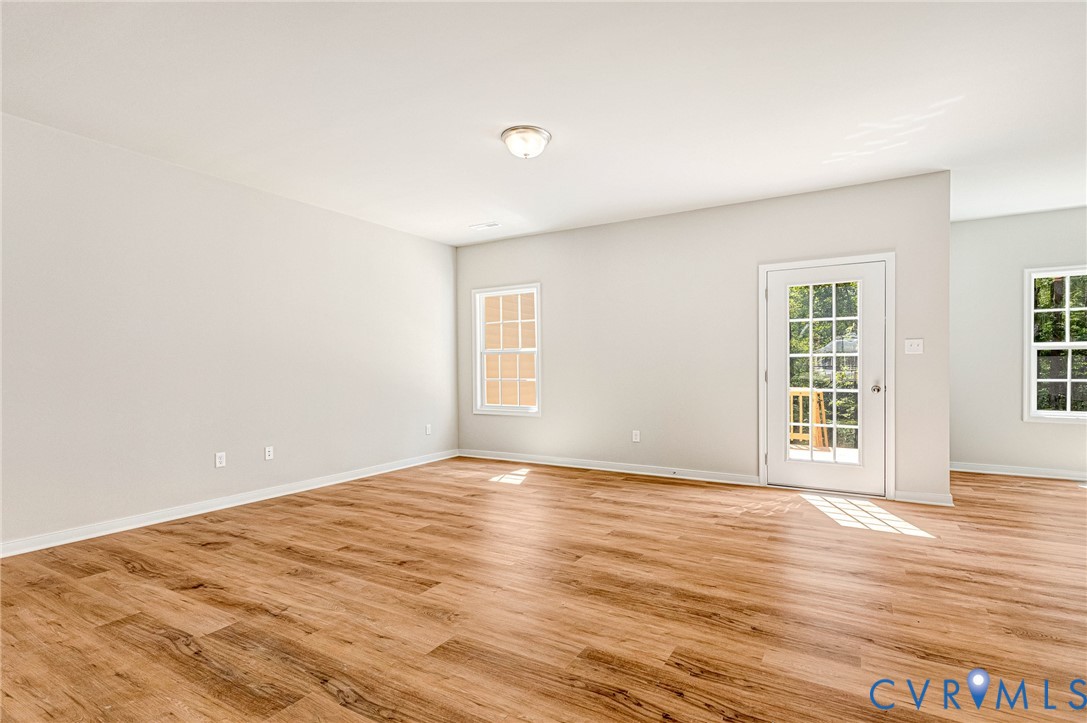 8355 Patrick Henry Boulevard Mechanicsville, VA 23116 - Photo 24 of 48 a view of an empty room with wooden floor and a window